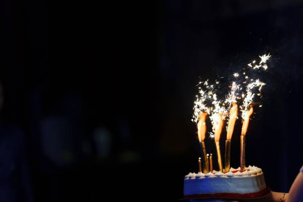 istock Cake with burning candles on a black background. banner. 2156476839