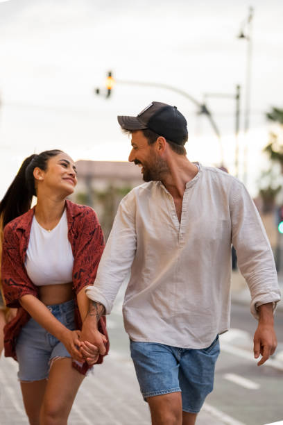 istock Smiling Couple Enjoying Casual Urban Stroll 2156477329