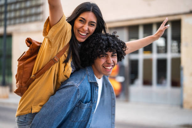 istock Joyful Couples Enjoying Piggyback Fun in Urban Setting 2156477380