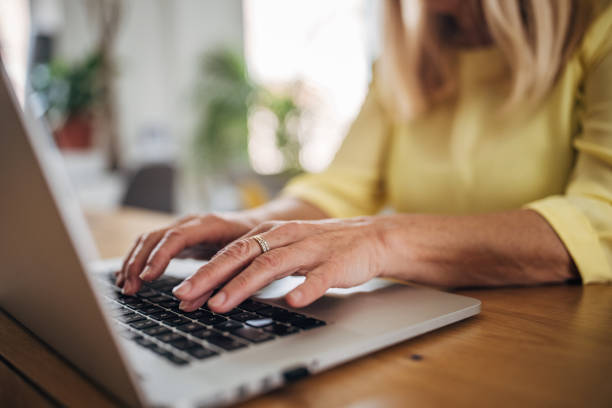 istock Senior white woman typing on a laptop 2156479117