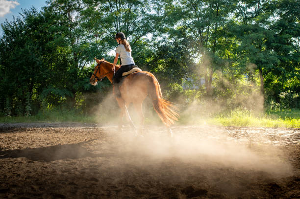 istock woman riding a horse 2156480958