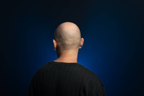 istock Bearded, bald middle-aged man with his back to the camera. Photo in studio. 2156483097