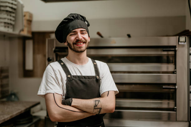 istock portrait of young handsome pizza baker chef 2156483370
