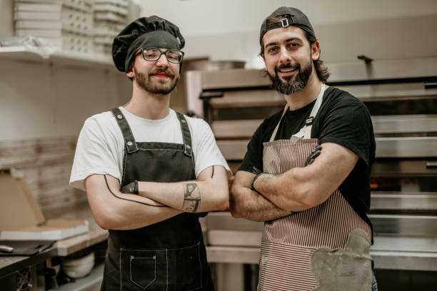 istock portrait of two handsome pizza baker 2156483372