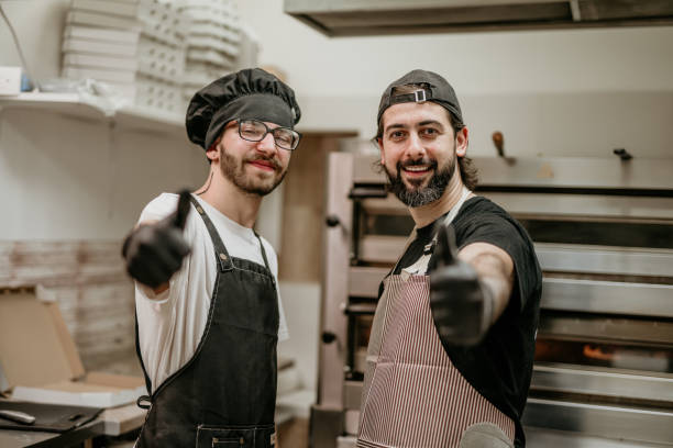 istock portrait of two handsome pizza baker 2156483455