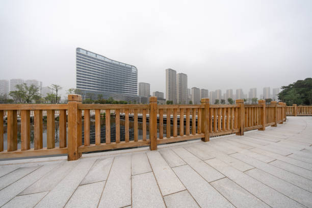istock The empty boardwalk by the lake and urban architecture 2156486849