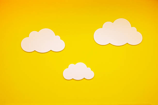istock decorative yellow background with white clouds. Children's decorations for holidays, hospitals and other institutions 2156487236