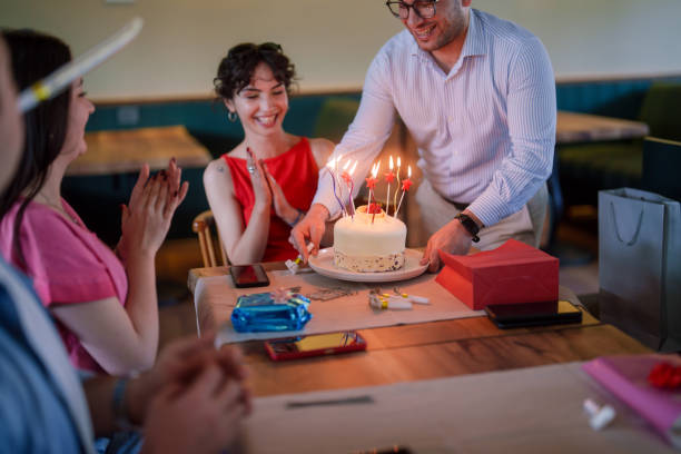 Part of a Series: Young woman is celebrating her birthday with friends at the restaurant