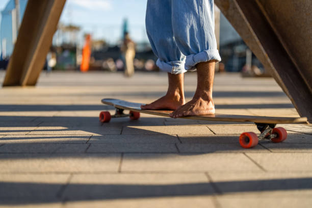 istock Barefoot Hispanic Male Skateboarding Outdoors 2156488662