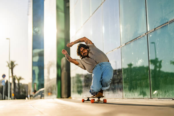 istock Hispanic Male Skilled Longboard Trick in Urban Setting 2156488698
