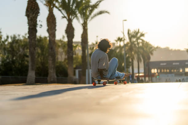 istock Skillful Hispanic Skateboarder Performs Longboard Tricks Outdoors 2156488730