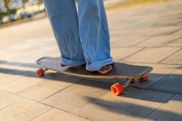 istock Hispanic Male Gliding on a Longboard Outdoors 2156488732