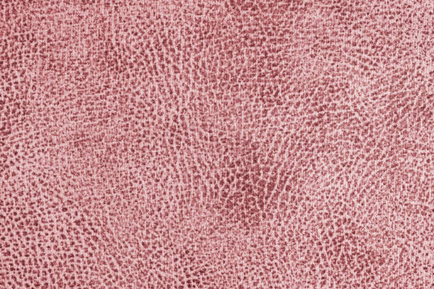 Jacquard red fabric with abstract shabby texture close up, macro. Upholstery, curtain decorative cloth structure, canvas for home decor. Background, backdrop, wallpaper.