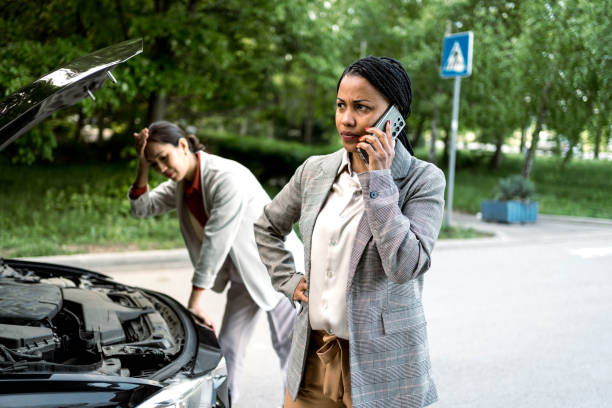 istock Two business women with broken car 2156492700
