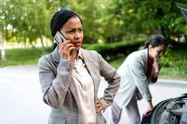istock Two business women with broken car 2156492722