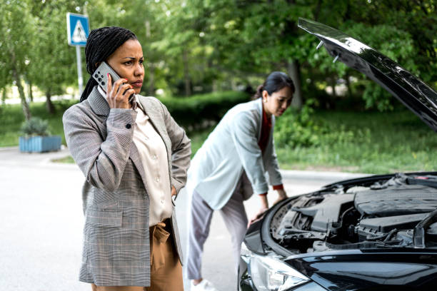 istock Two business women with broken car 2156492962