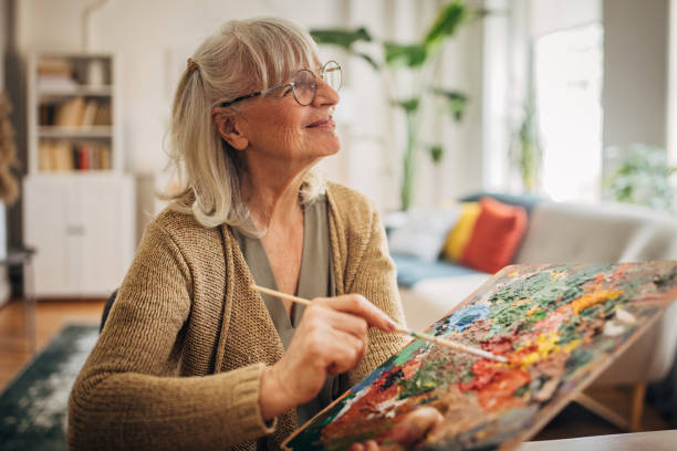 istock Senior woman painting on canvas 2156493019