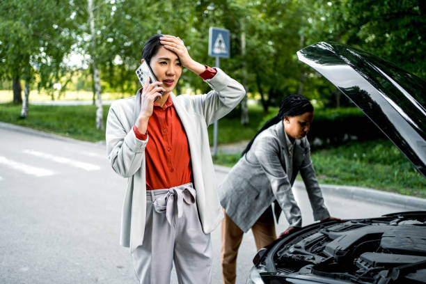 istock Two business women with broken car 2156493020