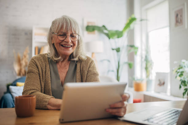 istock Senior woman talking on video chat over digital tablet 2156493337