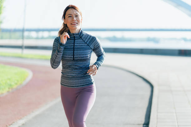 istock Happy sportswoman running 2156493434