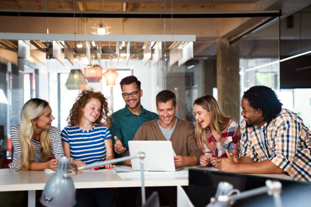 istock Smiling diverse colleagues gather in boardroom brainstorm discuss financial statistics together 2156493690