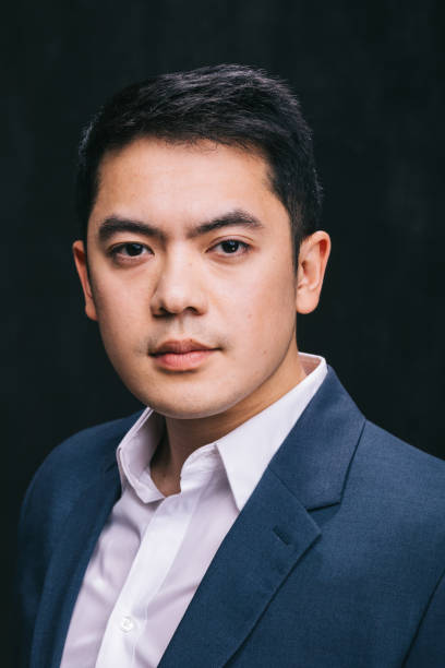 istock Young Asian professional stands confidently in a studio setting 2156493718