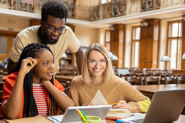 istock Group of young people working together and looking involved 2156494208