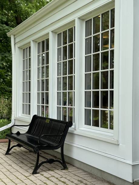 istock Black metal bench in front of white building with large windows 2156494568