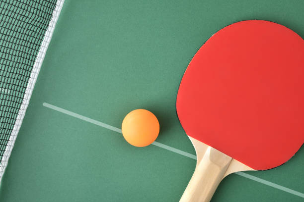 istock Ping pong paddle and ball on green game table top 2156494901