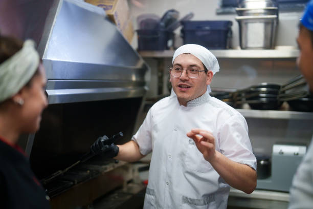 istock Restaurant Chef is talking to coworkers. 2156495515