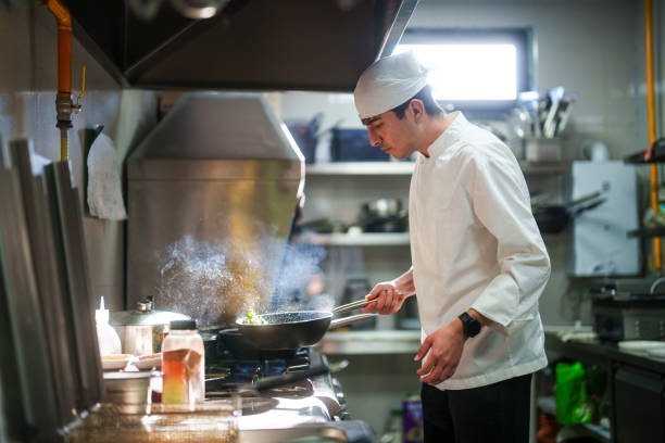 istock Chefs is cooking in the restaurant kitchen with frying pan. 2156495661