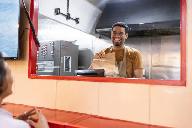 istock Black man delivering packaged food 2156497264