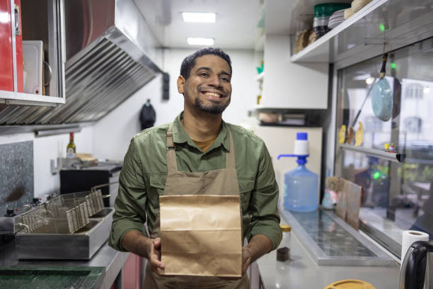 istock Black man with packaged food 2156497416
