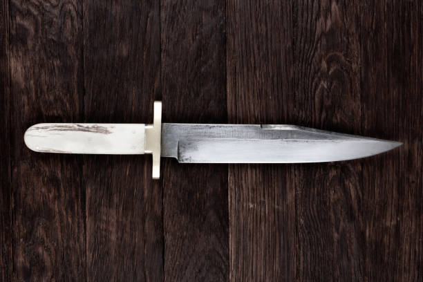 istock Old west bowie knife on wooden deck 2156500903