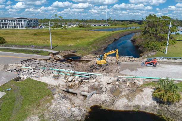 istock Destroyed bridge after hurricane flooding in Florida. Construction equipment at roadwork site. Reconstruction of damaged road after flood water washed away asphalt 2156501274