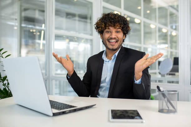 istock Businessman with curly hair explaining in modern office 2156501676