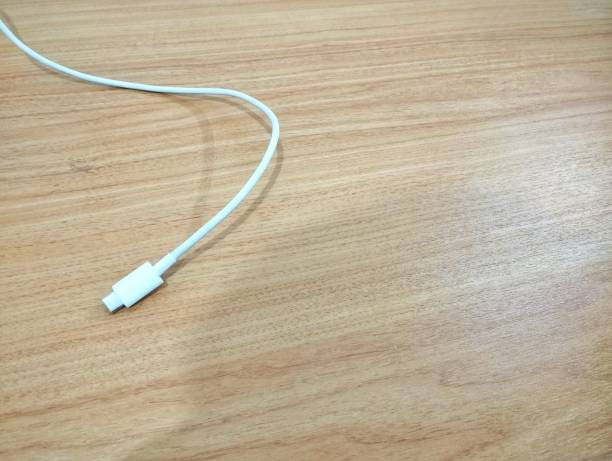 White charger cable on a wooden board