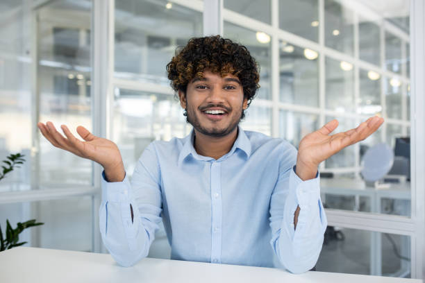 istock Friendly young businessman engaging in a casual office discussion 2156504716