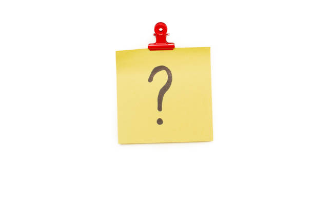 istock Question mark on a yellow sticky paper hanging from a red clip on a white background 2156504717