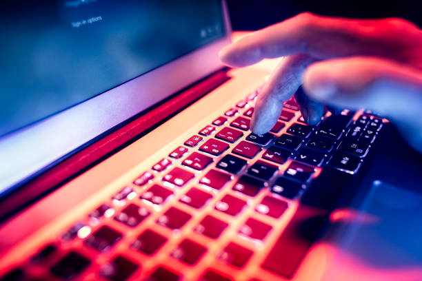 Using laptop searching internet or browsing information late at night in the dark