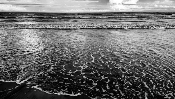 istock Wave and sandy beach in black and white. Calm view during sunset 2156506768