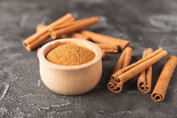 istock Cinnamon sticks on  background. Cinnamon roll. Spicy spice for baking, desserts and drinks. Fragrant ground cinnamon. cinnamon powder Close-up. Place for text. copy space 2156507350