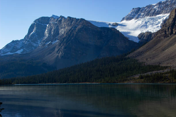 Colorful dawn, southeastward view from Bow Lake N shore to the snowy Waputik Mountains peaks (R-L) Crowfoot (north-centre-main), Bowcrow, Bow, Hector (main, little) and Andromache. Banff NP-AB-Canada.