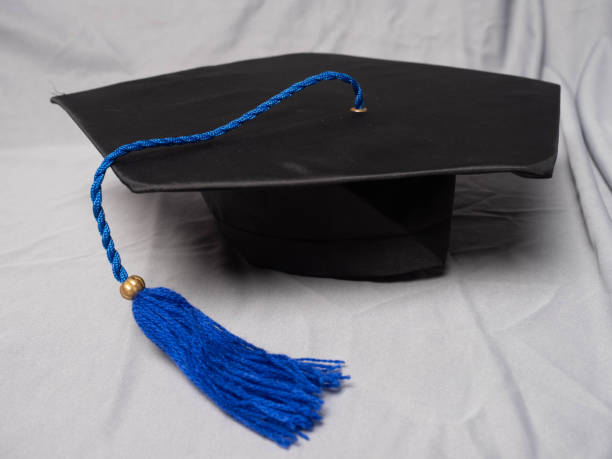 Blue graduation hat isolated on white background