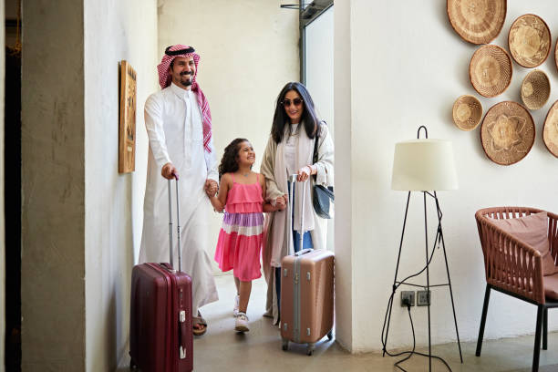 istock Happy Middle Eastern family holding hands in villa 2156513559