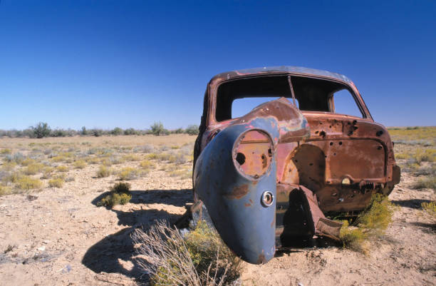 istock Abandoned old rusty car in the desert 2156513825