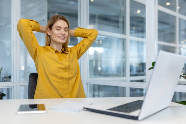 istock Relaxed professional woman taking a break at her office desk 2156513888