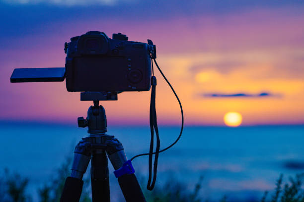 istock Camera taking photos of sunrise over sea 2156514549