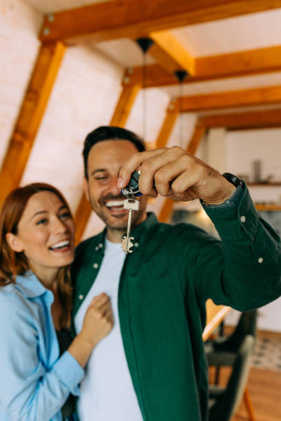 istock Happy married couple showing their new house key 2156515501