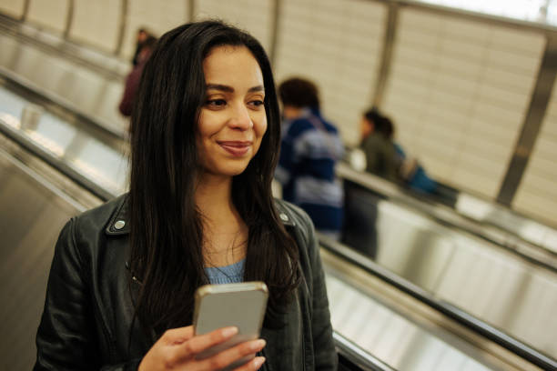 istock A young female riding the escalator towards the subway 2156515669